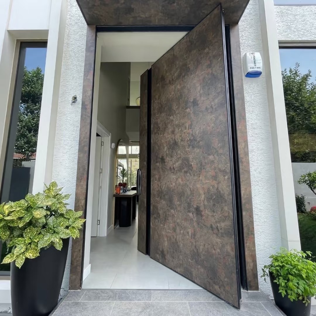 TINNO Patinated Metal Pivot Door: Rustic Luxury for Contemporary Homes
